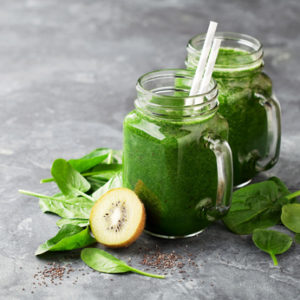 Healthy green smoothie with spinach, kiwi and chia seeds in a jar mug