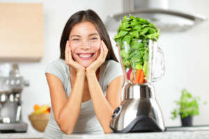 Green smoothie woman making vegetable smoothies